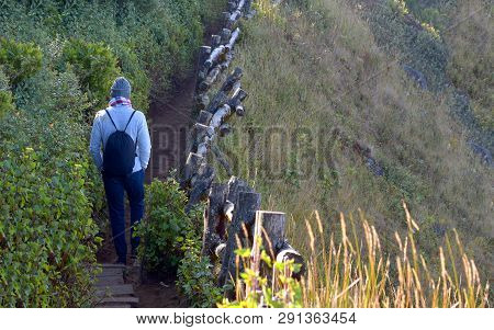 Traveler Traveling On Footpath Beside A Cliff, Ecotourism In Beautiful Nature Environment In Trail O