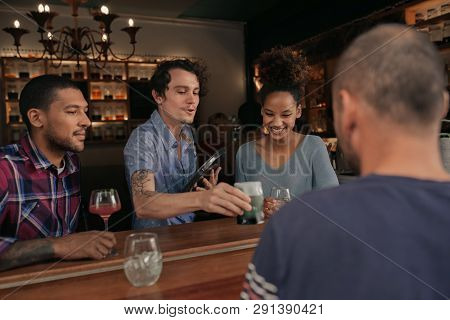 Smiling Friends Getting Their Drinks Order In A Bar