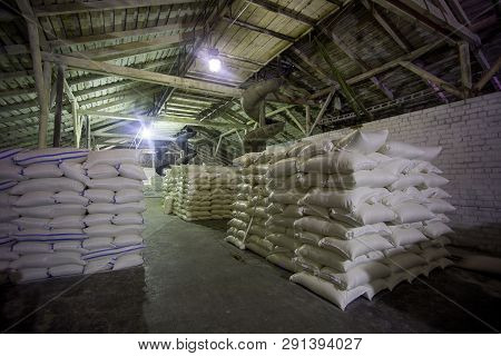Theme Plant Storage Warehouse. A Lot Of White Fabric Bags With Loose Products Stacked In Piles Indoo