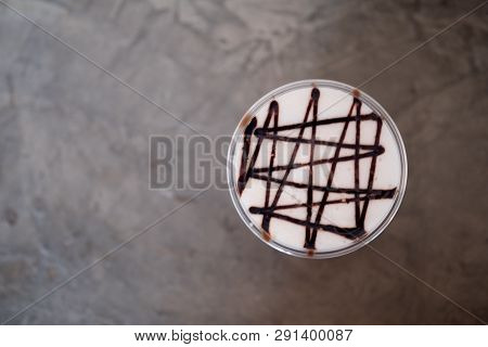 Iced Coffee With Chocolate Sauce On Milk Froth