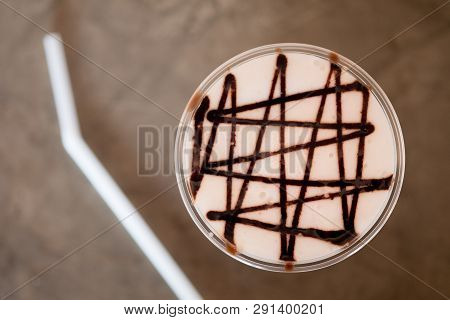 Iced Coffee With Chocolate Sauce On Milk Froth