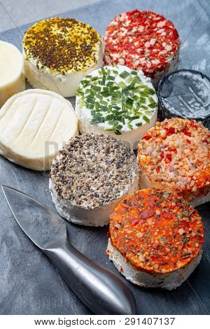 Assortment Of French Fresh White Soft Goat Cheeses With Different Tastes Topping Made With Herbs, Pa