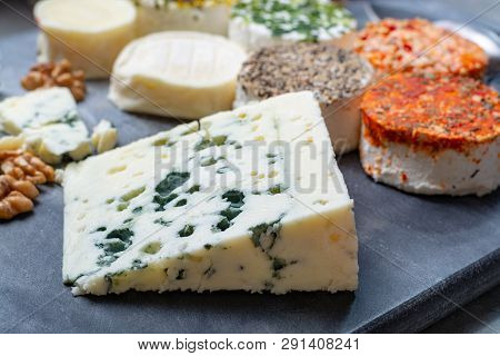 Assortment Of French Fresh White Soft Goat Cheeses With Different Tastes Topping Made With Herbs, Pa
