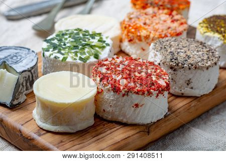 Assortment Of French Fresh White Soft Goat Cheeses With Different Tastes Topping Made With Herbs, Pa