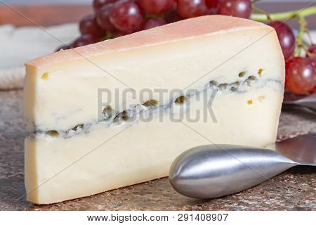 Piece Of Morbier Semi-soft Cow Milk French Cheese With Black Mold Layer