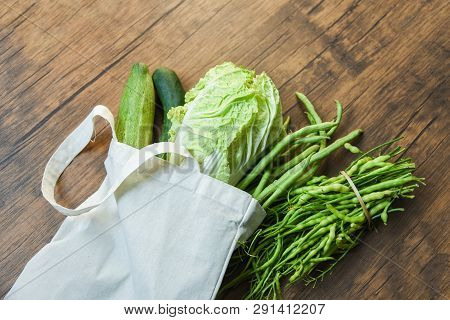 Zero Waste Use Less Plastic Concept / Fresh Vegetables Organic In Eco Cotton Fabric Bags On Wooden T