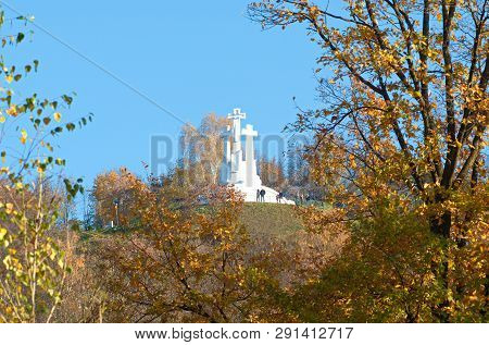 The Sculpture Of Three Crosses On The Hill In Vilnius, Lithuania, Surrounded By Vibrant Autumn Trees