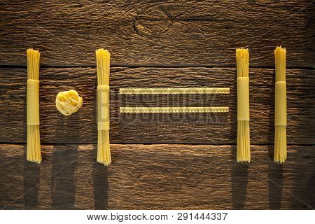 Pasta Placed With Geometric Signs On A Wooden Background