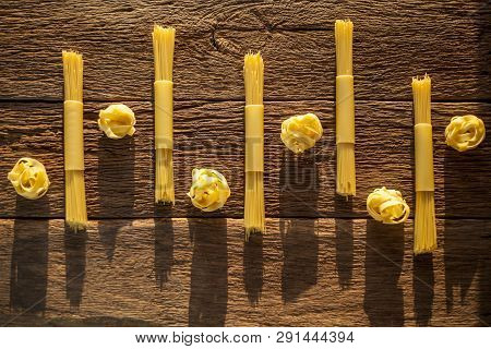 Pasta Placed With Geometric Signs On A Wooden Background
