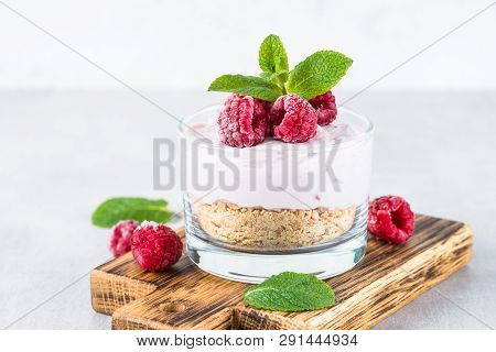 No Baked Cheesecake With Raspberry In Glass Jar. Healthy Dessert.