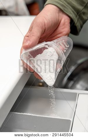 Man Hand Filling Detergent In The Washing Machine, Concept Housekeeper, Househusband