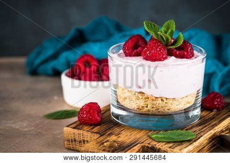 No Baked Cheesecake With Raspberry In Glass Jar. Healthy Dessert.