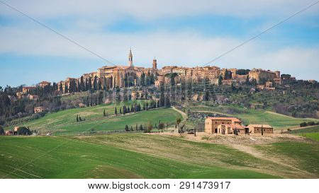 Hills Of Meadows Below The Medieval Village Of Pienza In Tuscany