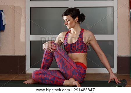 Young Sporty Woman Practicing Yoga, Doing Mahamudra Stretching Position In A Fitnes Club