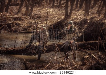 Hunters Resting In Forest Spring During Hunting Season
