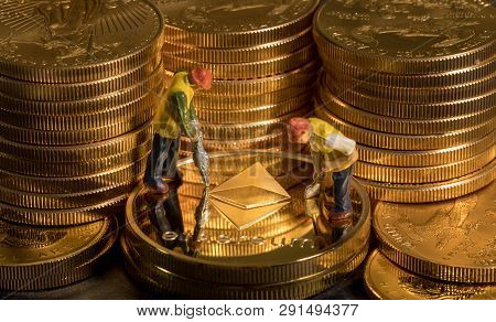 Concept Illustration Of Two Miners Mining New Ethereum Cybercurrency Virtual Coins In The Blockchain