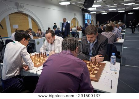 ST. PETERSBURG, RUSSIA - DECEMBER 27, 2018: Men compete in King Salman World Rapid Chess Championship 2018. In front Peter Svidler, Russia (right) vs Boris Gelfand, Israel