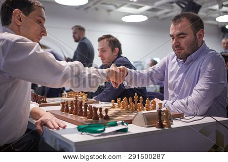 ST. PETERSBURG, RUSSIA - DECEMBER 29, 2018: Grandmaster Shakhriyar Mamedyarov, Azerbaijan (right) handshakes with Robert Hovhannisyan, Armenia before the match of World Blitz Chess Championship 2018