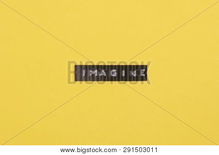Concept Imagine - Label Print With The Word Imagine On Yellow Background