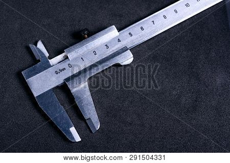Vintage Steel Caliper On Dark Background. Scale In Focus. Tool In Very Good Condition. Stock Photo O