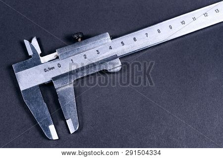 Vintage Steel Caliper On Dark Background. Scale In Focus. Tool In Very Good Condition. Stock Photo O