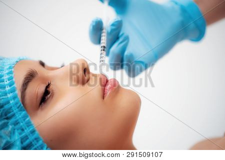 The Doctor Cosmetologist Makes The Rejuvenating Facial Injections Procedure For Tightening And Smoot