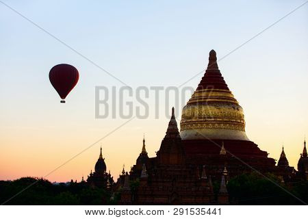 Stunning sunrise view of hot air balloons fly over  Dhammayazika Pagoda historic buddhist temple in Bagan Myanmar