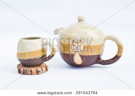 Teapot And Ceramic Stoneware Cup With White Background