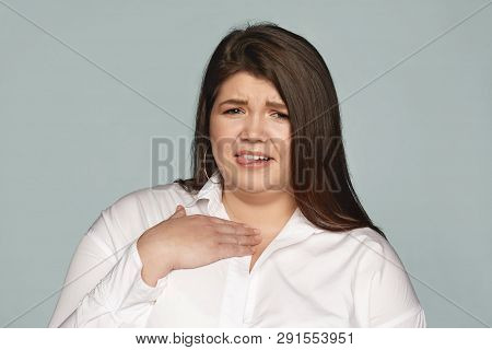 Gross, Ew. Portrait Of Emotional Displeased Young Chubby European Woman Grimacing, Sticking Out Tong