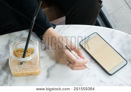 Some Women Using Smartphone In Coffee Shop