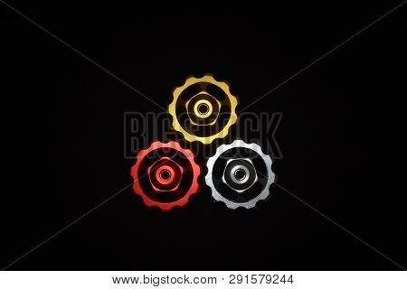 Color Rollers, Black, Golden, Silver Gears For Bicycle Rear Derailleur On Black Background In Shape 