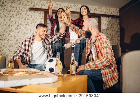 Football fans wathing tv broadcast at home