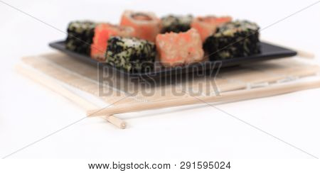 Different Types Of Maki Sushi On A Black Plate