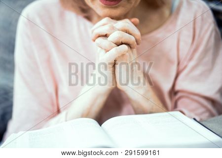 Middle Aged Woman Reading Bible. Put Hands Together In Pray.closed Eyes. Selective Focus Oh Hands An