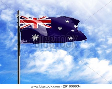 National Flag Of Australia On A Flagpole In Front Of Blue Sky.