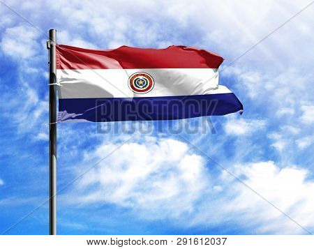National Flag Of Paraguay On A Flagpole In Front Of Blue Sky.