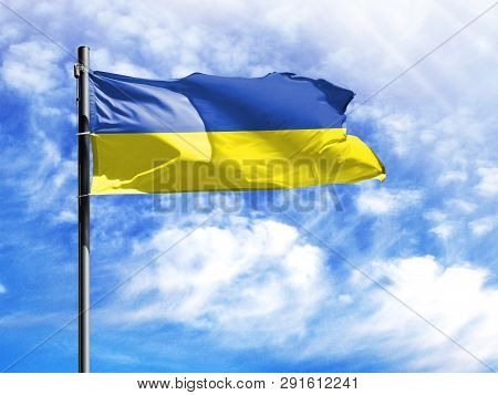 National Flag Of Ukraine On A Flagpole In Front Of Blue Sky.