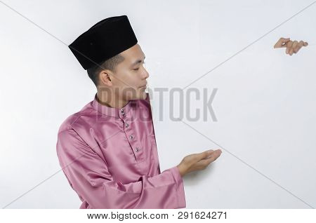 Portrait Of Young And Handsome Asian Man With Traditional Clothing Holding White Cardboard
