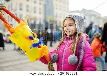 Cute Girl Wearing Frightening Masks During The Celebration Of Uzgavenes, A Lithuanian Annual Folk Fe