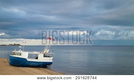 Fishing Boat On Baltic Sea Coast. Stormy Weather. Mechelinki, Poland, Pucka Bay.