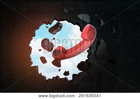 3d Rendering Of Red Landline Phone Receiver Breaking Through Black Wall With Blue Sky Visible From H