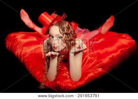 Sexy Burlesque Dancer Stripper Posing With Sweet Lollipop, In Red Corset And Red Hat With Curly Hair