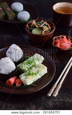 Mix Of Japanese Food - Rice Balls Onigiri, Omelette, Ginger, Sunomono Wakame Cucumber Salad. Traditi