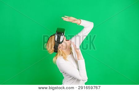 Woman Enjoying Cyber Fun Experience In Vr. Amazed Young Woman Touching The Air During The Vr Experie