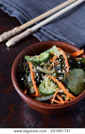 Japanese Salad Sunomono With Wakame, Cucumber, Onion And Carrot Sprinkled Sesame And Chopsticks. Asi
