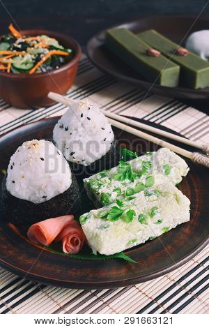 Mix Of Japanese Food - Rice Balls Onigiri, Omelette, Ginger, Sunomono Wakame Cucumber Salad. Traditi