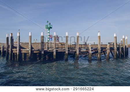 Breakwater With Beacon In Oudeschild Port At Texel Island On Sunny October Day