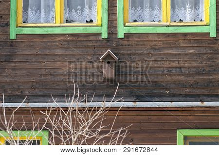 A Small Bird House On The Facade Of Wooden Country Style House, Outdoor Cropped Image