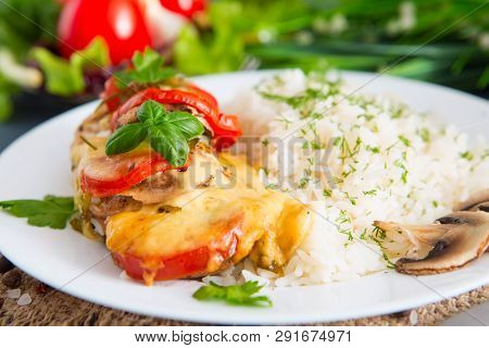 Chicken Fillet Baked In Cheese With Rice And Vegetables. Fired Cordon Bleu Chicken Served With Rice 