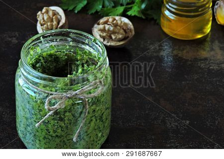 Walnut Pesto With Parsley. Homemade Pesto Sauce In A Jar. Top View. Vegan Pesto With Walnut And Pars